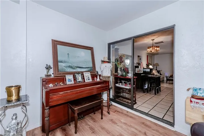 Miscellaneous room featuring an inviting chandelier and hardwood / wood-style flooring