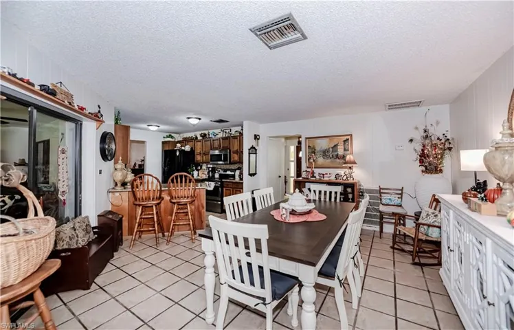Dining area featuring a textured ceiling and light tile patterned flooring