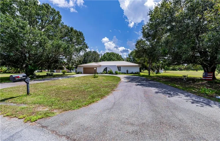 Single story home with a front lawn and a garage