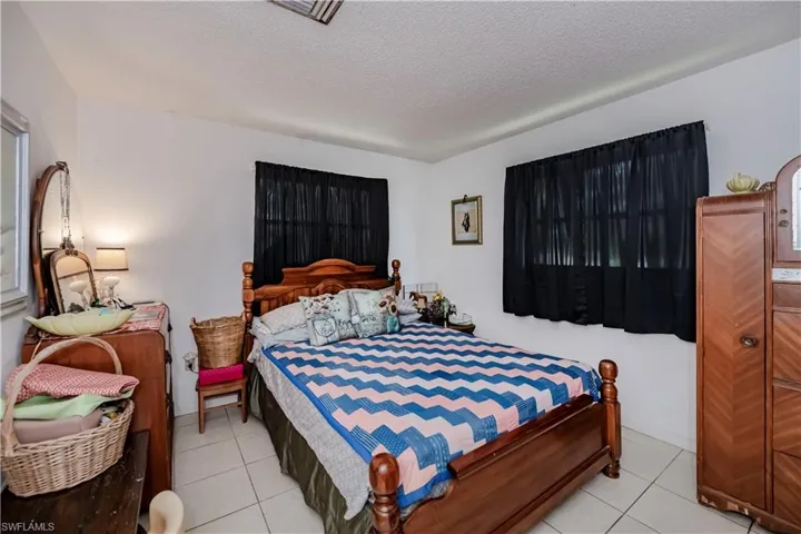 Bedroom featuring a textured ceiling and light tile patterned floors