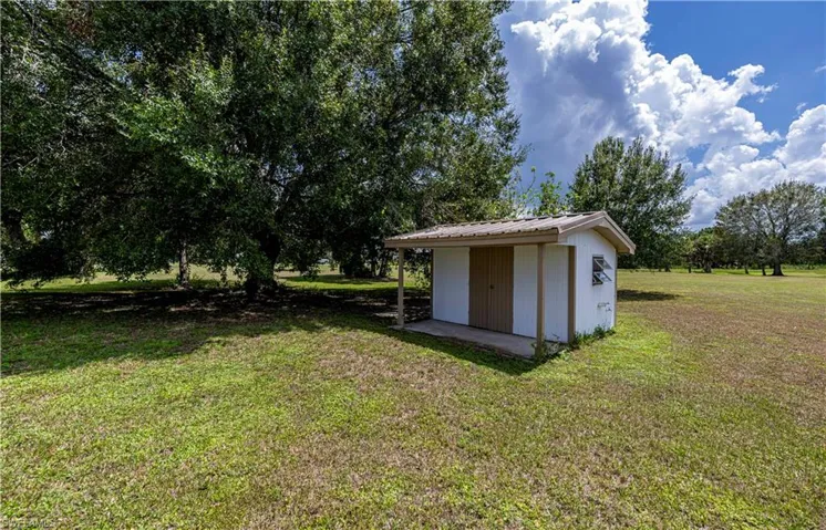 View of yard with a storage shed