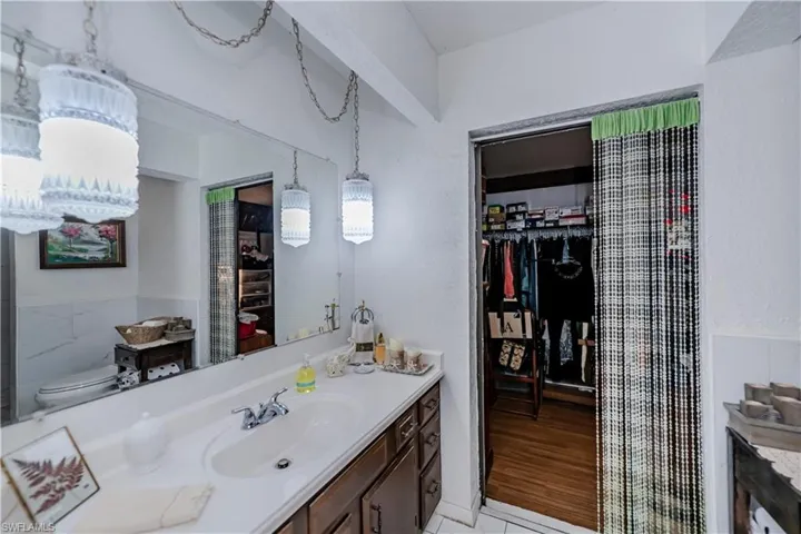 Bathroom featuring toilet, tile patterned floors, and vanity