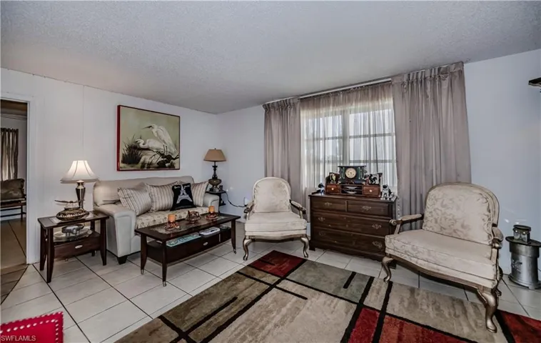Tiled living room with a textured ceiling