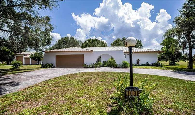 View of front of home featuring a garage and a front lawn