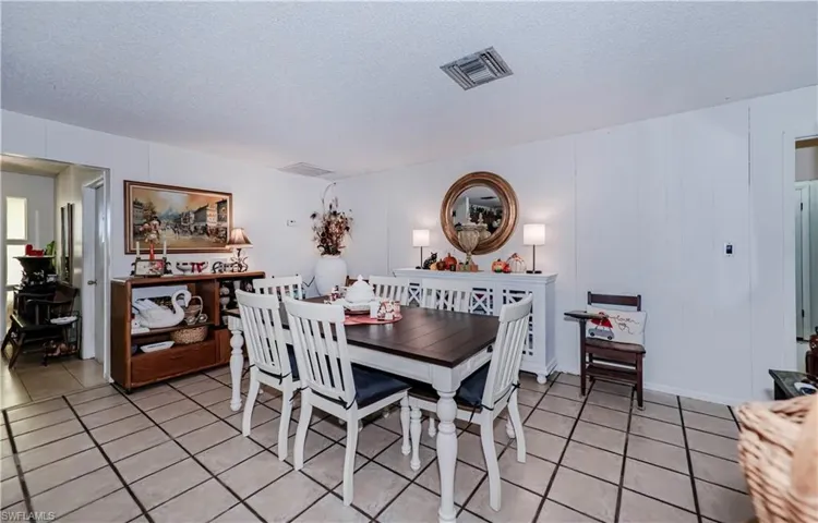 Tiled dining area featuring a textured ceiling