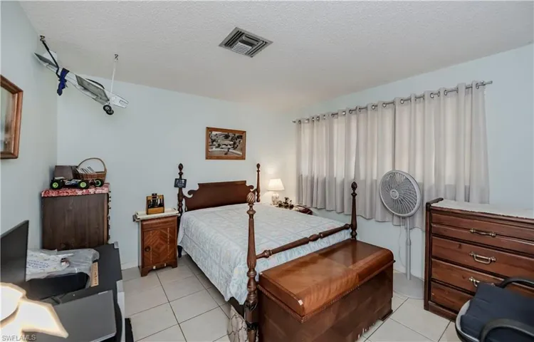 Tiled bedroom featuring a textured ceiling