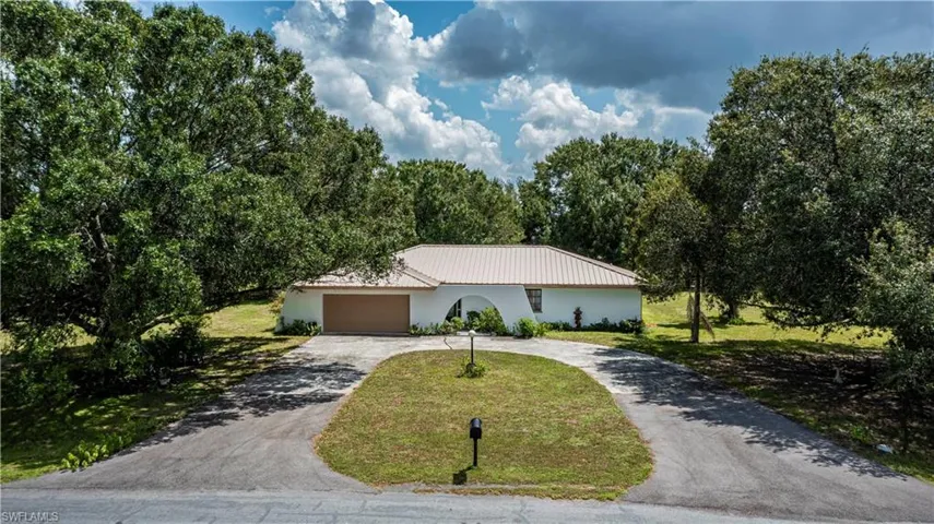 Ranch-style house featuring a garage and a front yard