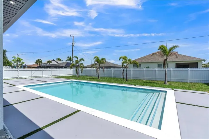View of swimming pool featuring a patio area and a fenced backyard