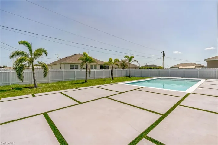 View of swimming pool with a fenced backyard and a patio area