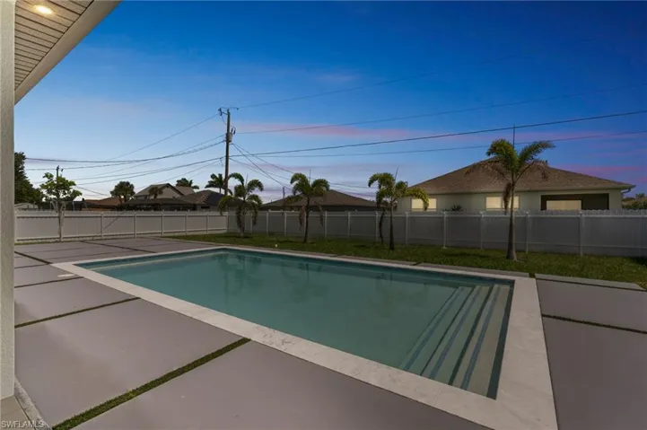 View of swimming pool featuring a patio and a fenced backyard