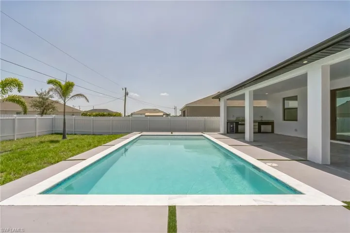 View of pool with a patio area and a fenced backyard