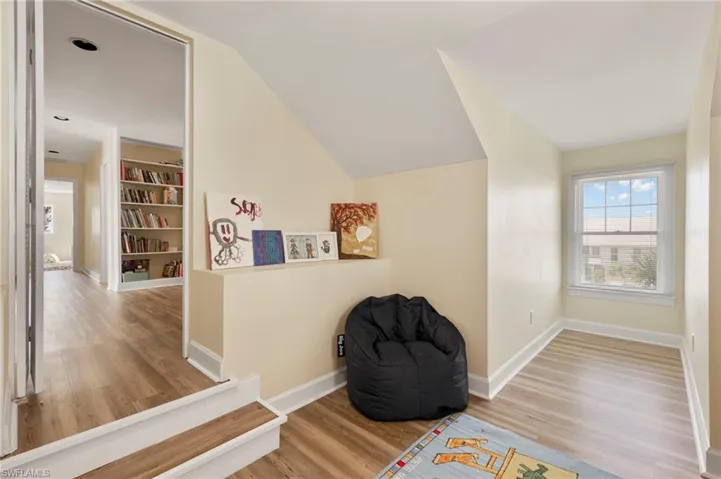 Sitting room with light wood finished floors and baseboards