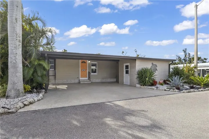 From the moment you arrive, you'll appreciate the home's inviting curb appeal featuring tropical landscaping, covered carport parking & a welcoming island-inspired exterior