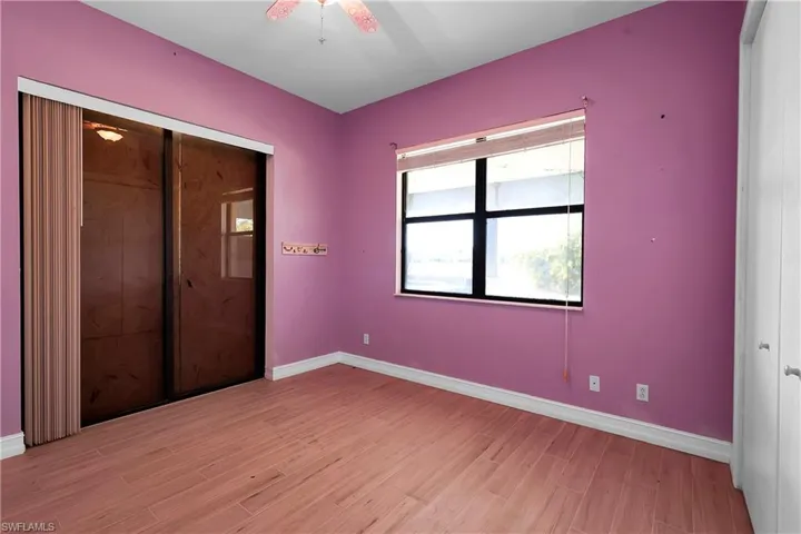 Unfurnished bedroom with a closet, light hardwood / wood-style flooring, and ceiling fan