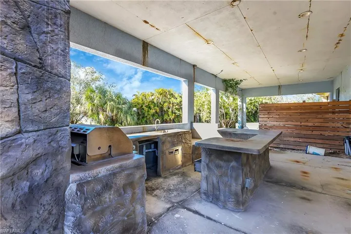 View of patio featuring sink, a grill, and exterior kitchen
