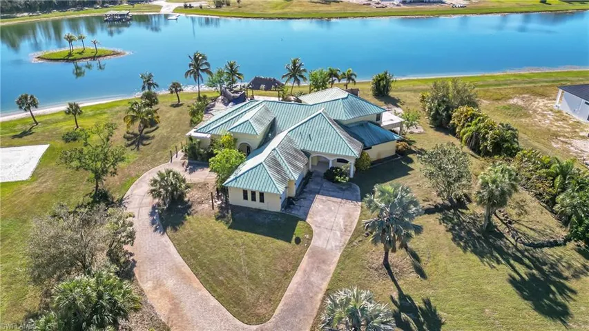 Birds eye view of property with a water view