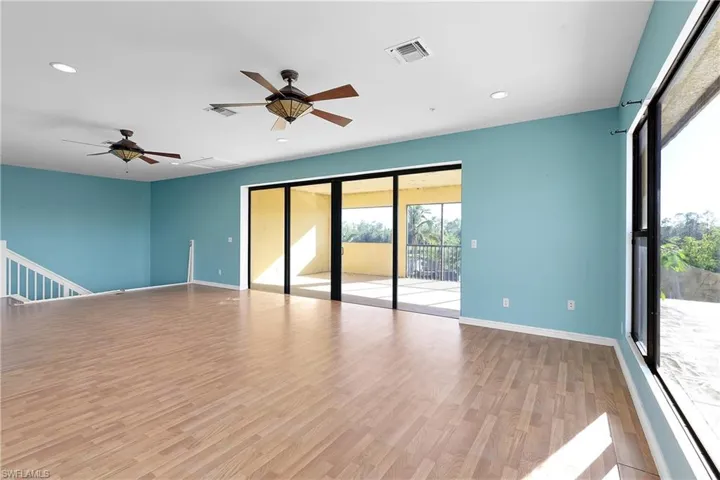 Empty room with ceiling fan and light hardwood / wood-style flooring