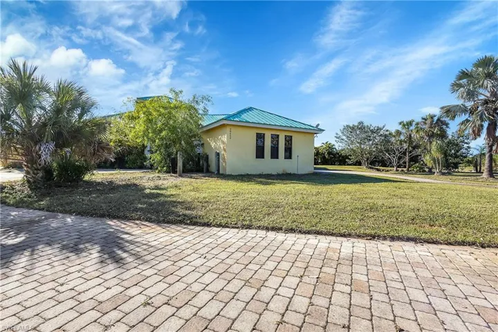Back of property with a yard