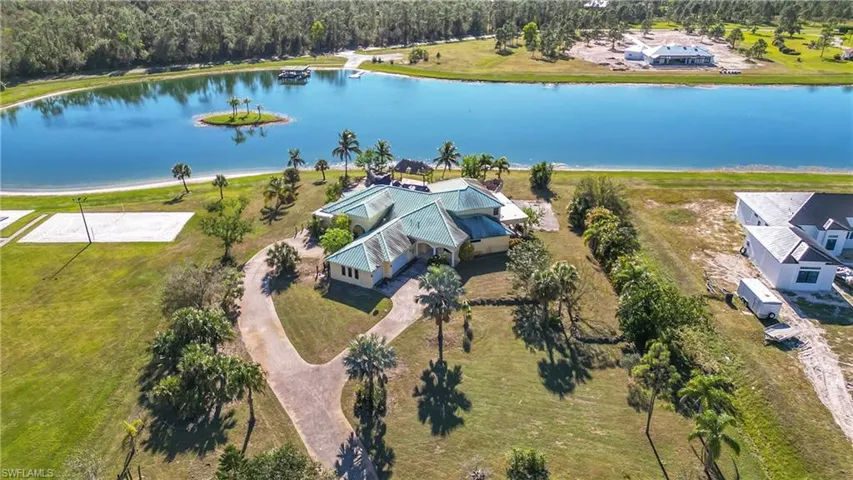 Birds eye view of property with a water view