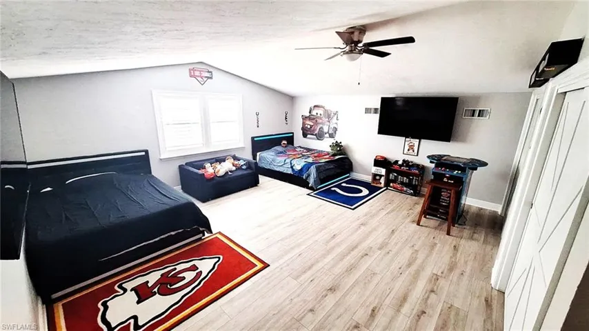 2nd Floor Master Bedroom featuring ceiling fan, visible vents, baseboards, wood finished floors, and vaulted ceiling