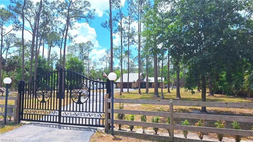 View of gate featuring fence