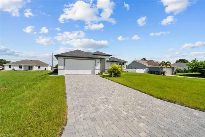 Single story home with a front yard and a garage