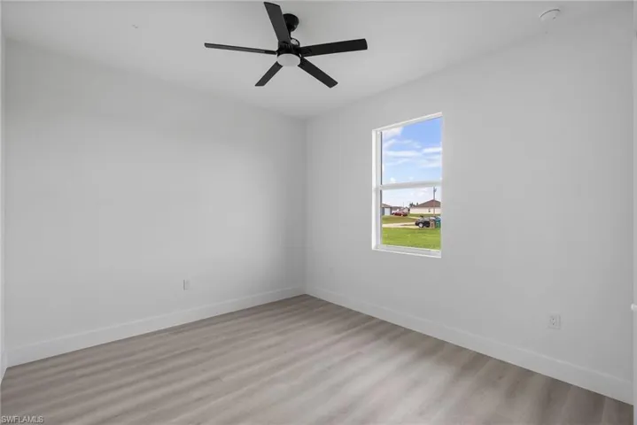 Unfurnished room featuring light hardwood / wood-style floors and ceiling fan