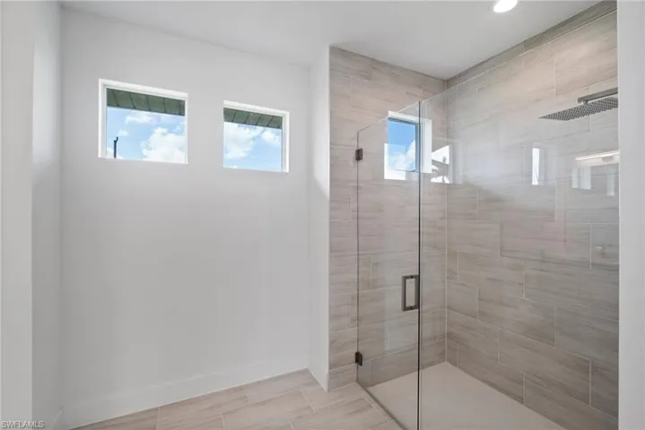 Bathroom featuring a shower with door