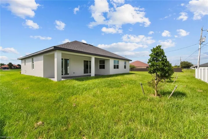 Back of property with a yard