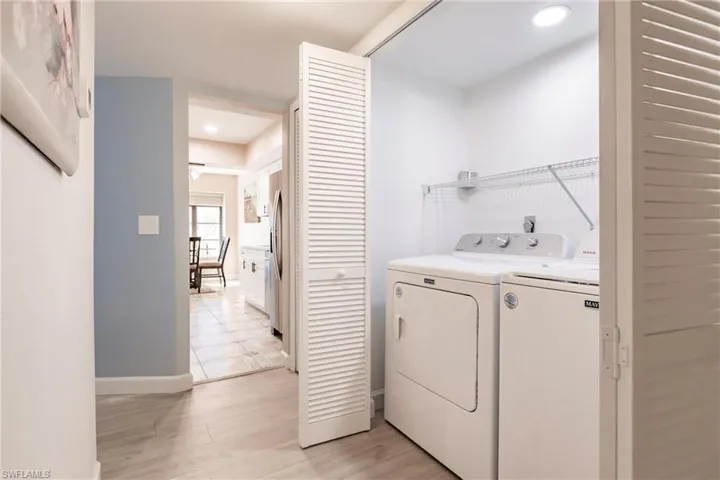 Laundry area featuring light wood-type flooring and separate washer and dryer