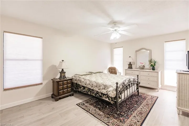 Bedroom featuring ceiling fan and light hardwood / wood-style flooring