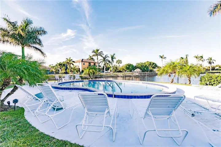 View of swimming pool with a patio area and a water view