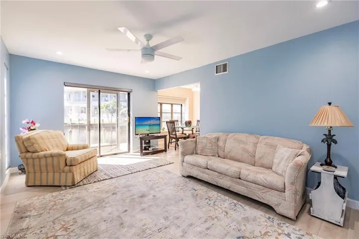 Living room featuring ceiling fan and light wood-type flooring
