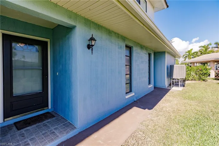 View of exterior entry featuring central air condition unit