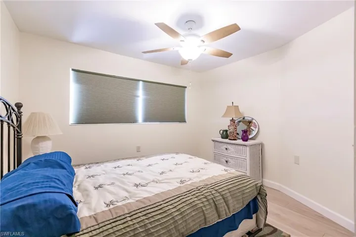 Bedroom with ceiling fan and light hardwood / wood-style flooring