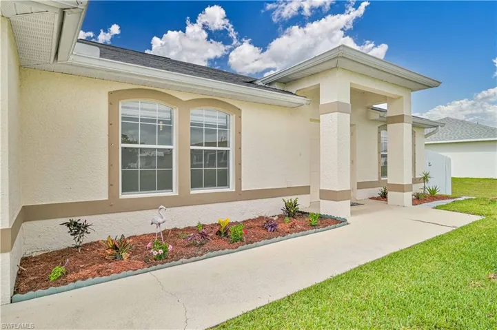 Doorway to property with a yard