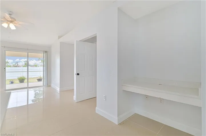 Tiled empty room with ceiling fan