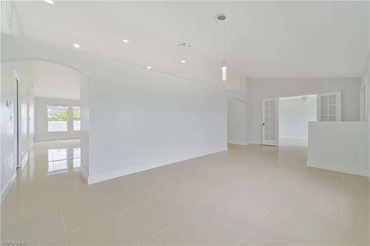 Tiled spare room with lofted ceiling and ceiling fan
