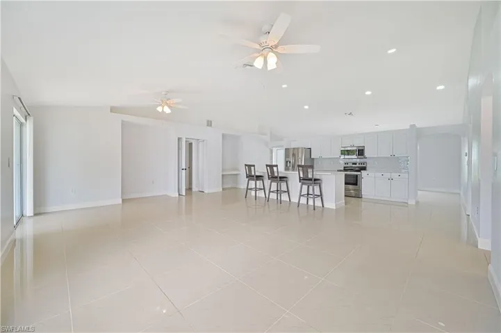 Tiled living room featuring ceiling fan