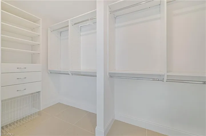 Spacious closet with light tile floors
