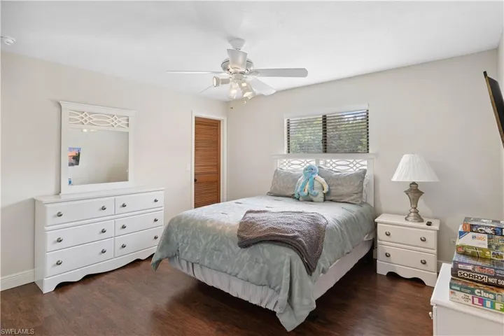 Bedroom with dark wood finished floors and ceiling fan