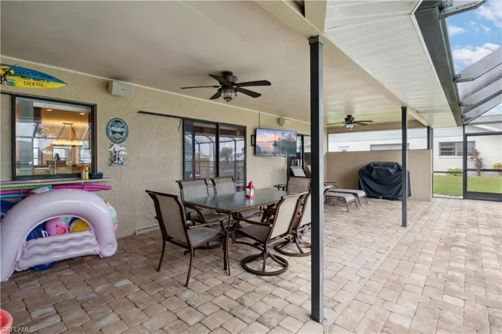 View of patio / terrace with a ceiling fan, a grill, a lanai, and outdoor dining area
