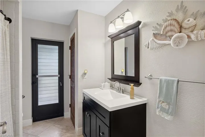 Bathroom featuring vanity and tile patterned flooring