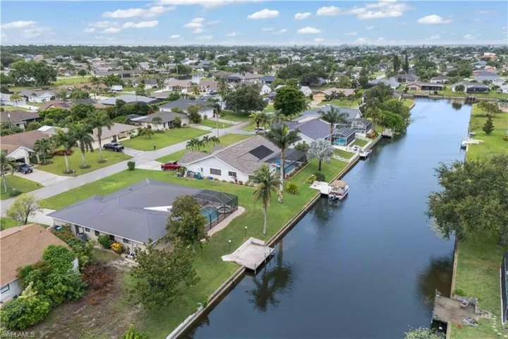 Aerial view of residential area featuring a nearby body of water