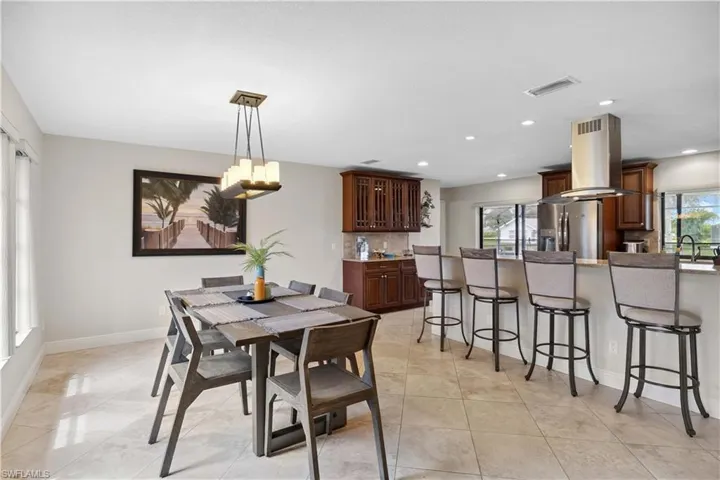 Dining area featuring recessed lighting, a chandelier, and light tile patterned flooring