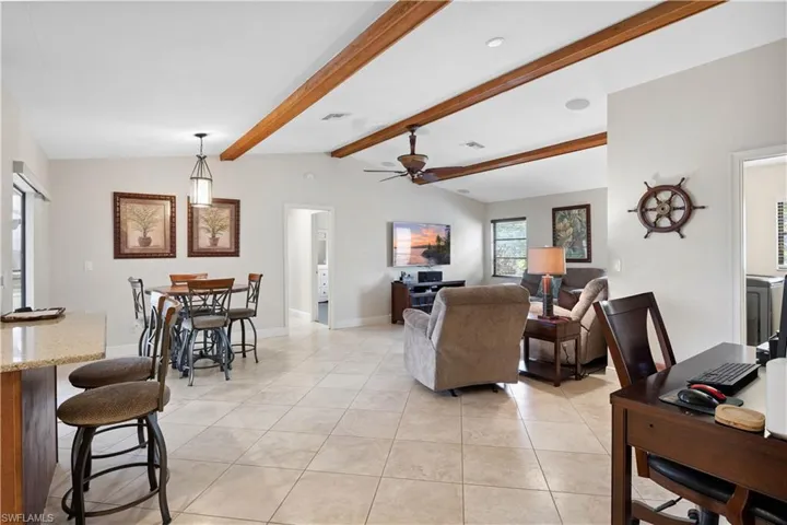 Living room featuring a ceiling fan and light tile patterned flooring