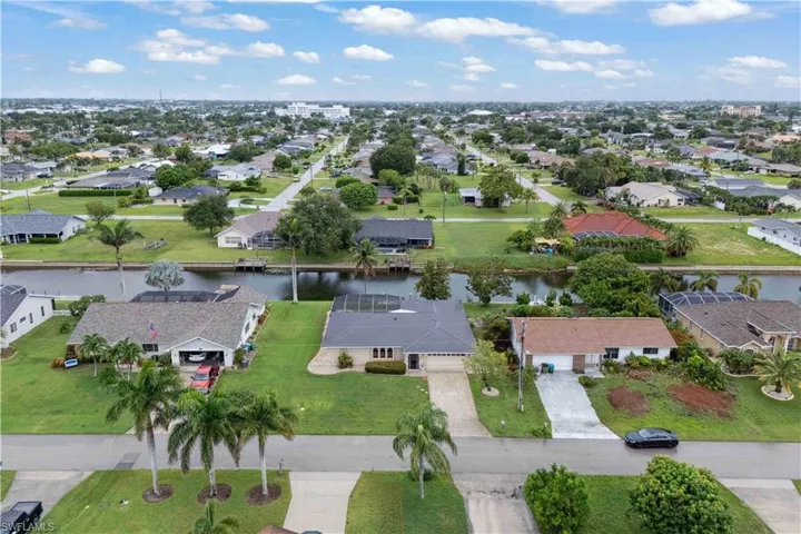 Aerial perspective of suburban area with a large body of water