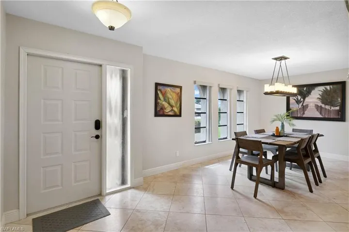 Dining room featuring light tile patterned flooring and a chandelier