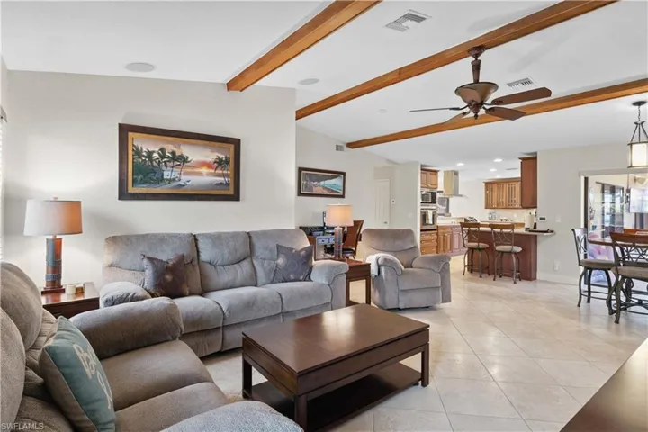 Living room featuring light tile patterned floors, a ceiling fan, and recessed lighting