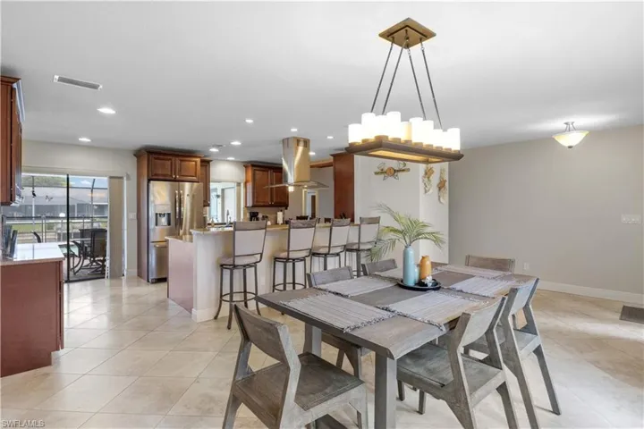 Dining area featuring recessed lighting and light tile patterned floors
